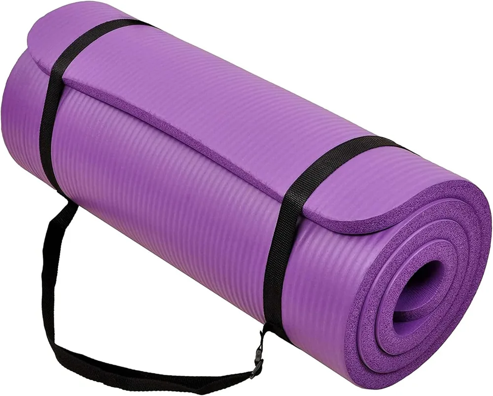 The BalanceFrom GoCloud one inch extra thick exercise mat in purple rolled with its carrying strap.