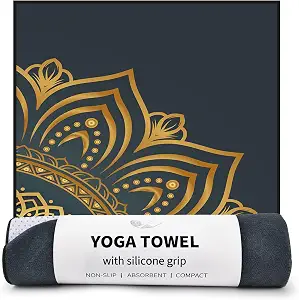 A yogi in child's pose on the Colorful Star gold mandala hot yoga towel.