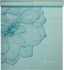 The Gaiam folding travel mat in serene dahlias teal lies flat with its sketched dahlia design.