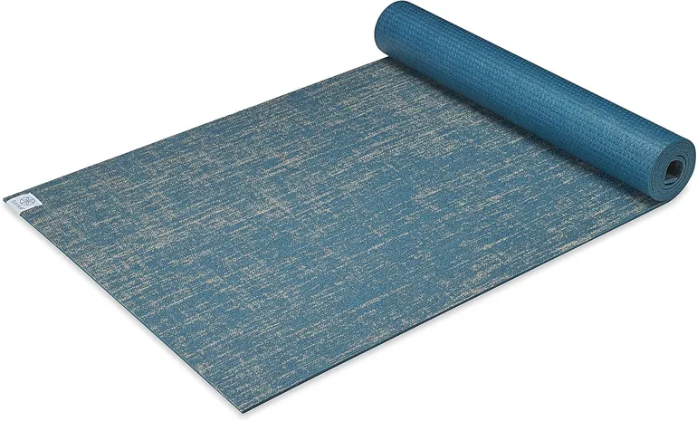 Rolled natural-tone Gaiam mat showing the jute weave top and printed band. 7 Best Jute Yoga Mats for Eco-Conscious Yogis Who Want Natural Grip