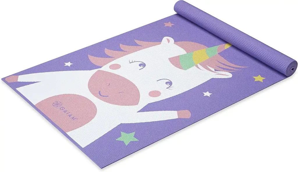 Purple kids yoga mat printed with a cartoon unicorn and stars, partly rolled. Best Kids Yoga Mats: 8 Comfortable and Colorful Options for Young Yogis