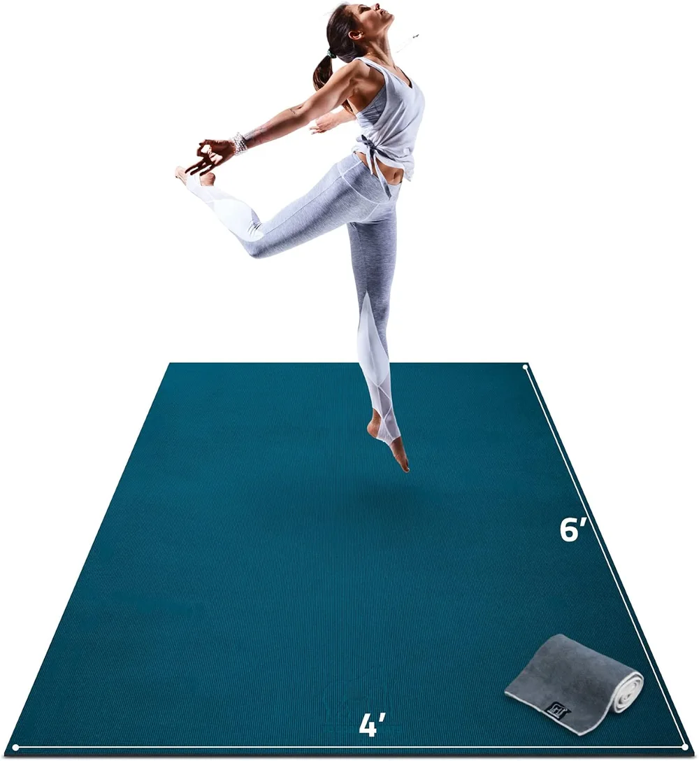 The Gorilla Mats large teal yoga mat at six by four feet with its towel and straps beside it.
