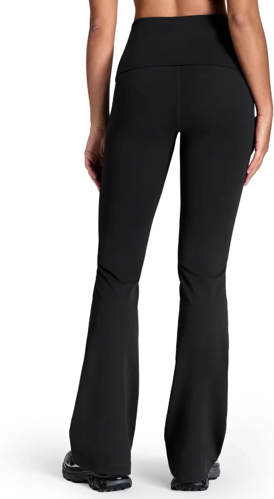 The HeyNuts Mellow fold over flare leggings in black show their fold-over waistband from behind in the product image.
