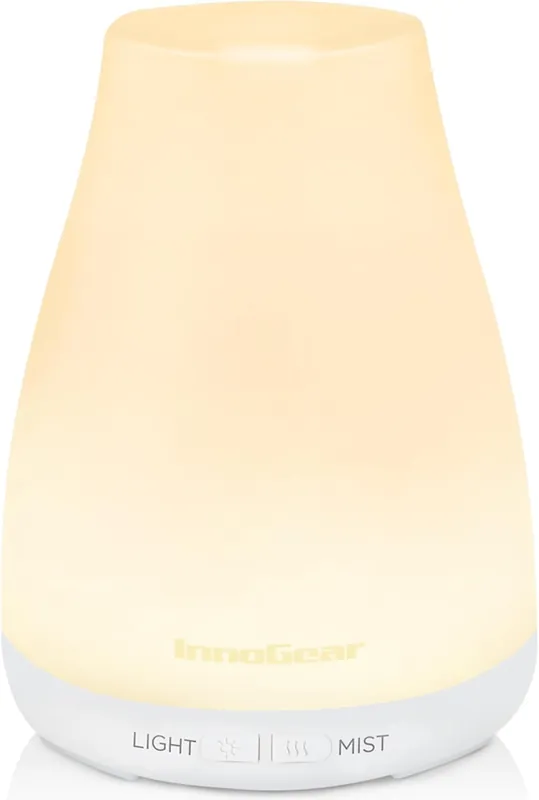 glowing white ultrasonic diffuser with light and mist controls at the base