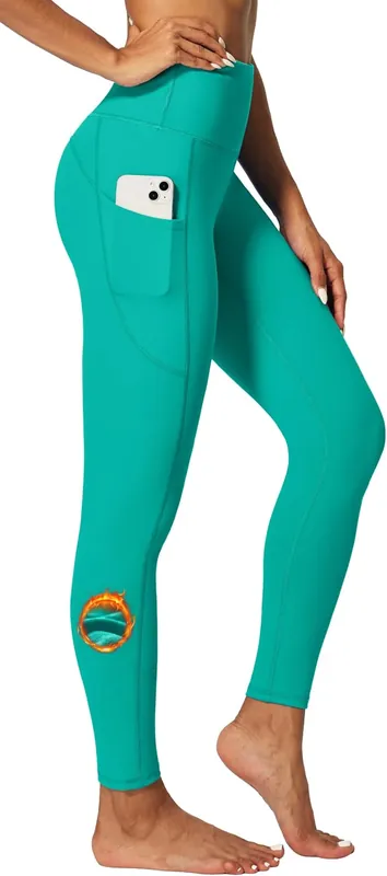 aqua green leggings with a deep side pocket holding a phone