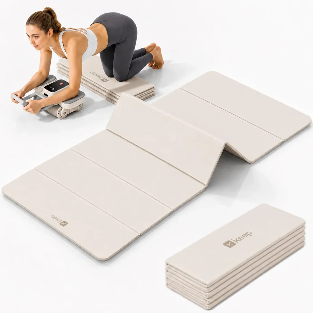 The KEEP foldable yoga mat in oat white stands angled with its carry loops visible.