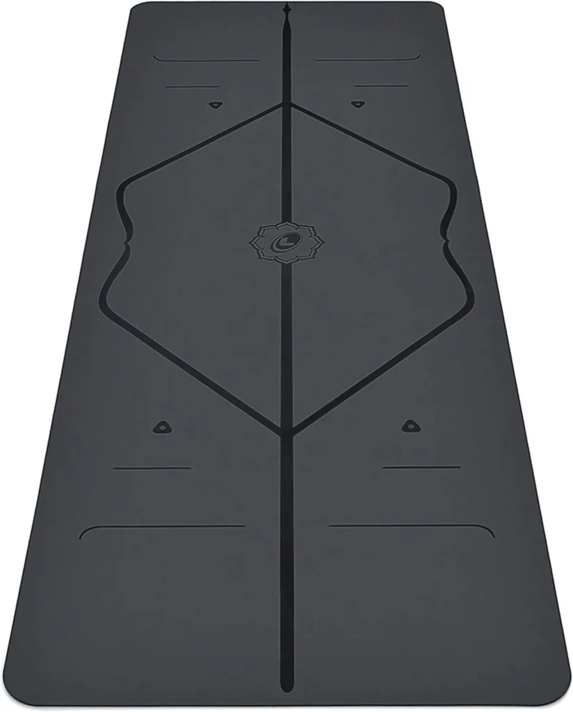 A dark grey Liforme Classic yoga mat laid flat with its engraved body alignment markers running down the center.