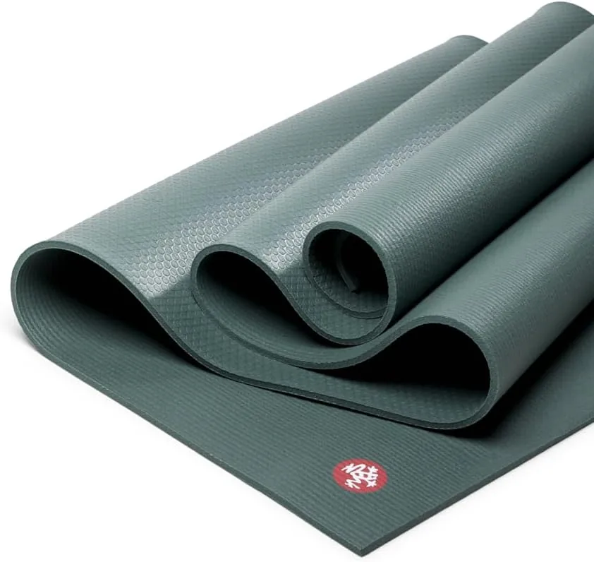 The Manduka PRO mat in black sage lies folded with its rolled form beside it. 7 Best Yoga Mats for Bad Knees With Extra Cushioning for More Comfortable Practice