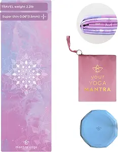 The Mantra Yoga Travel PRO in soft purple lies folded beside its round knee pad and carry bag. Best Travel Yoga Mats: 9 Lightweight Picks for Yogis Who Need Easy Packing