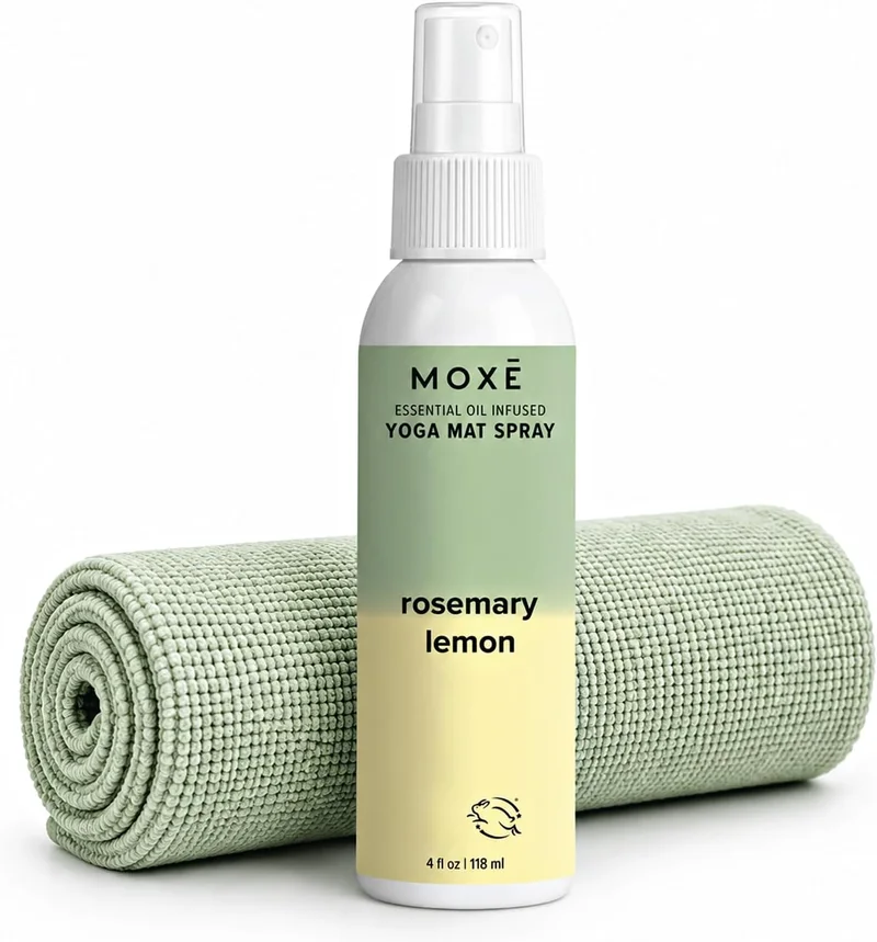 The MOXE yoga mat cleaner spray bottle in rosemary lemon on a rolled mat.