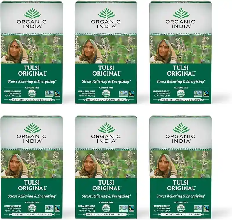 Six white and green Organic India Tulsi boxes with portraits