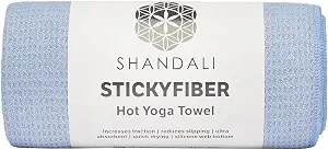 The Shandali Stickyfiber hot yoga towel rolled in blue. 7 Best Yoga Towels for Hot Yogis Who Need Better Grip