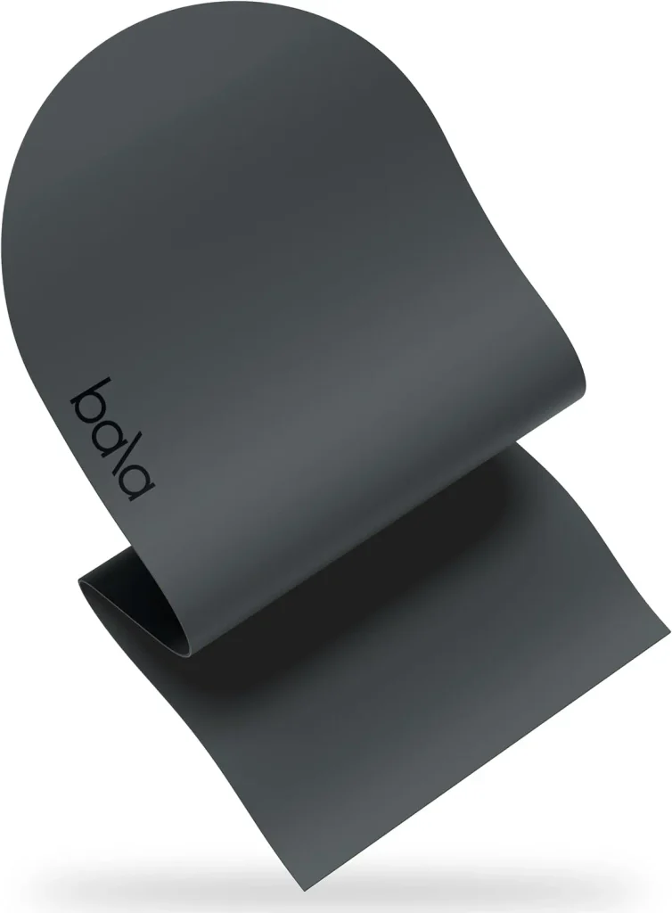 The Bala Play Mat in charcoal stands tightly rolled with its smooth PU top facing outward.