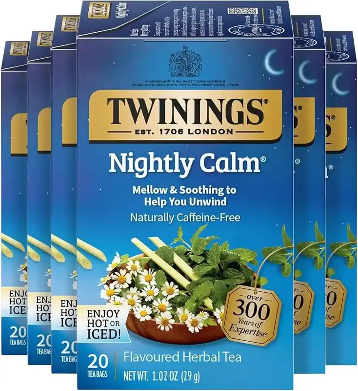 Blue Twinings boxes stacked with gold seals and chamomile photos