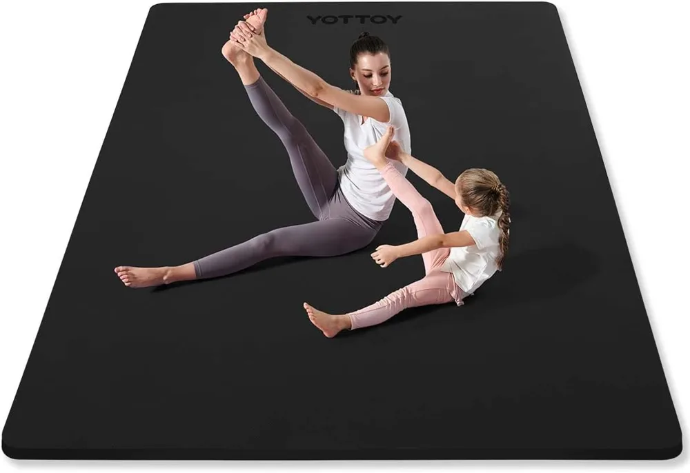 The YOTTOY large yoga mat in dark grey showing its half inch thickness and double size floor coverage.
